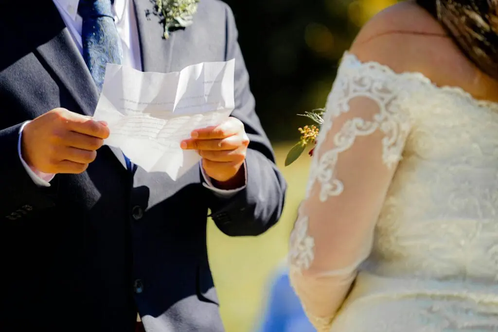 A couple exchanging heartfelt vows during their outdoor wedding ceremony