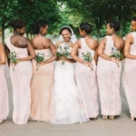 A group of bridesmaids, each wearing a unique yet cohesive dress style, posing together with the maid of honor, showcasing her ability to coordinate a stylish and cohesive bridal party look.