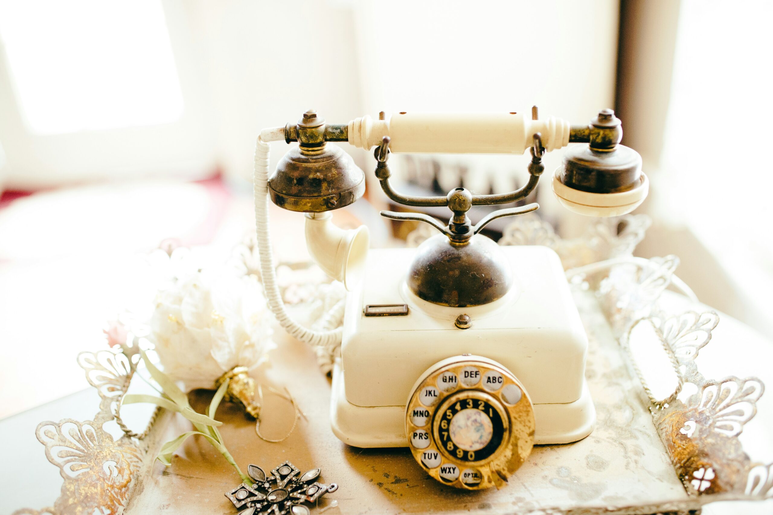 A vintage telephone booth with a sign saying 'Leave your message here!'