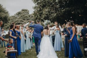![A couple exchanging vows in a beautiful outdoor ceremony, surrounded by their loved ones and the breathtaking natural scenery.](couple-exchanging-vows.jpg)