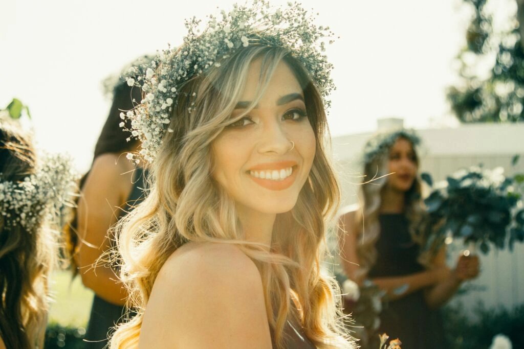 A maid of honor respectfully participating in a cultural wedding ritual alongside the bride and her family, demonstrating her willingness to learn and embrace diverse traditions.