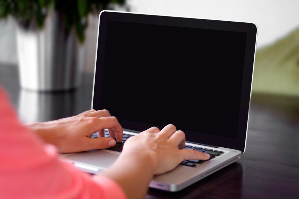 A laptop screen showing a virtual audio guest book interface with a 'Leave a Message' button.