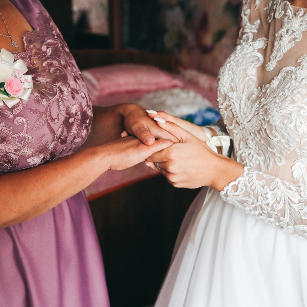 Mother of the Bride and Bride holding hands