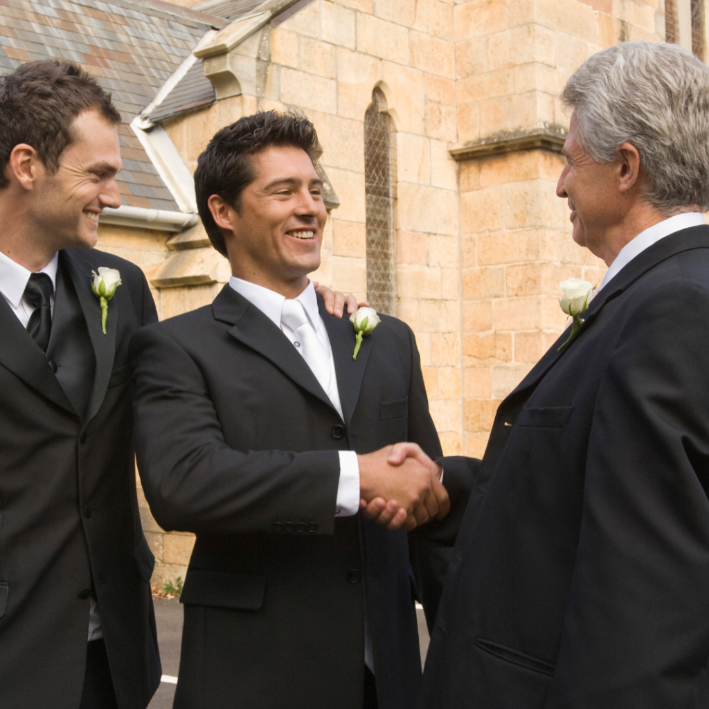 groom and father shaking hands at the wedding