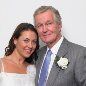 bride and father close to each other looking at camera