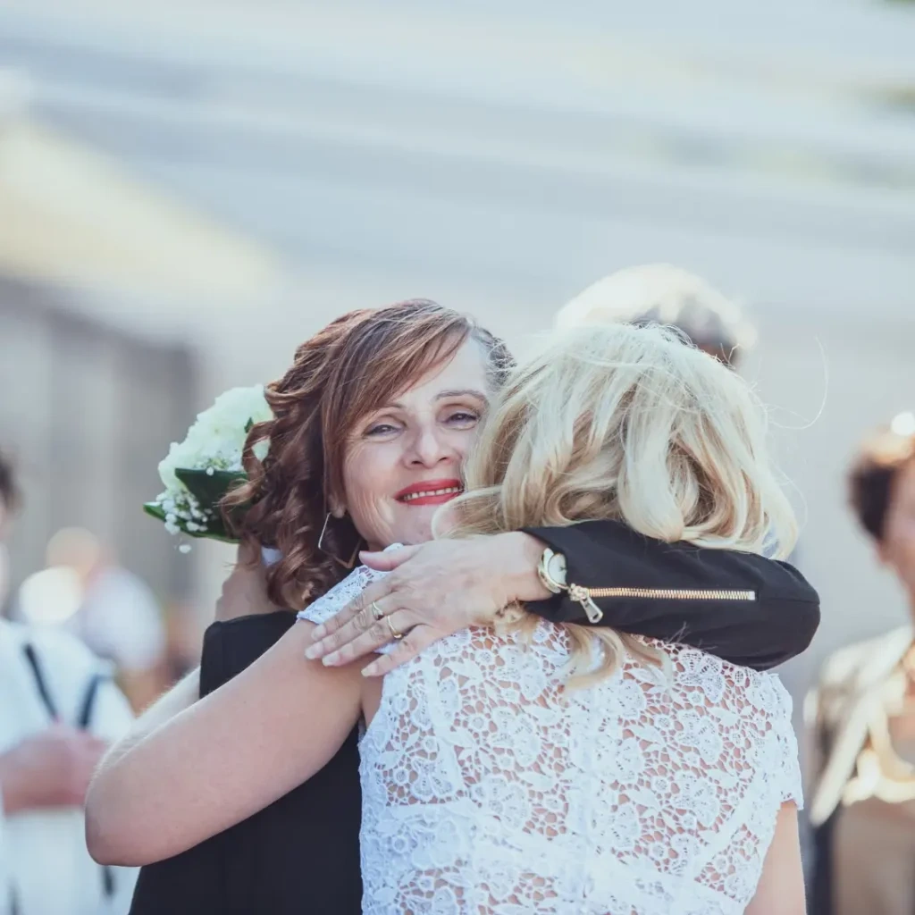 mother hugging her daughter in wedding dress