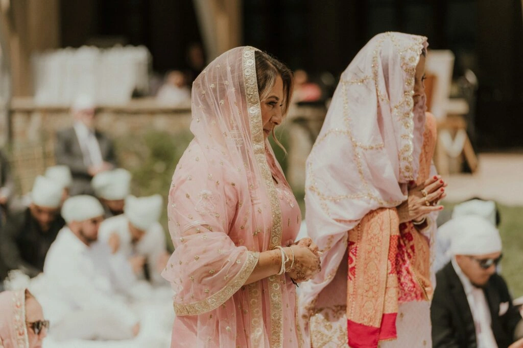 Mother of the Bride and Bride standing next to each other at the ceremony