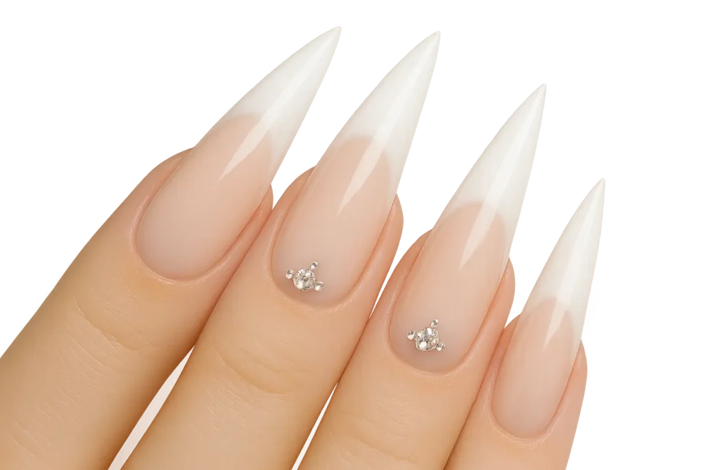 Bridal stiletto nails photographed with wedding rings and bouquet